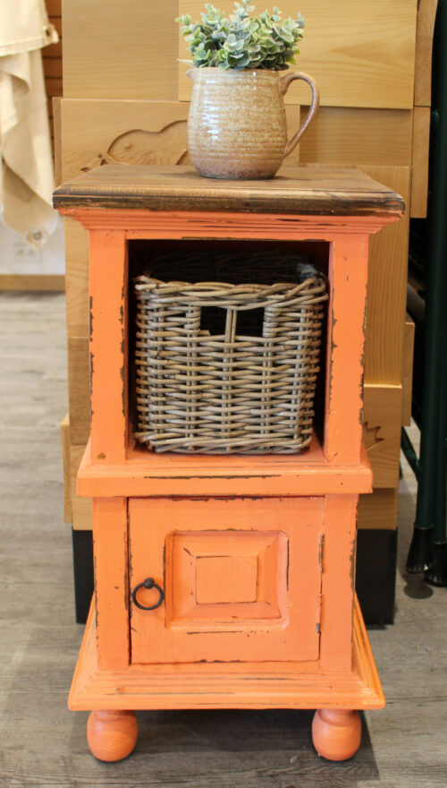 Shabby Chic Collection: End table in Coral orange with a raftwood finished top. Front view with a basket in room setting - CC-TAB016TLD-CRRW-B